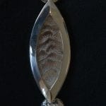 One part of the silver ceremonial chain of office for the Mayor. This one representing the Okstindan mountains.