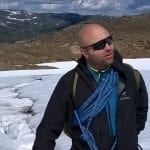 Frank from Rivjoen Adventure with sunglasses and glacier equipment on, standing on the glacier, Vestisen, in Okstindan.
