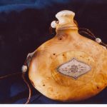 Wooden drinking bottle with decorations in bone and sami pictograms.