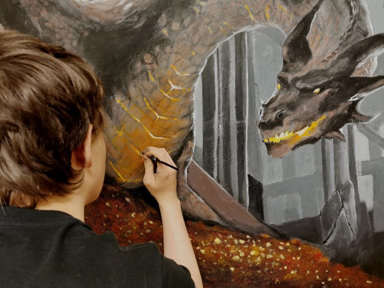 Boy painting a dragon