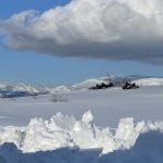 View from the window of snow cowered moutains.