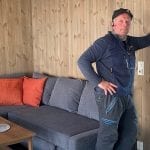 Handyman Asgeir in front of the sofa in the living room.