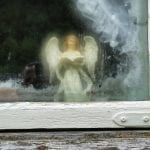 Small angel figure in the window at Inderdalen Farm watching over the farm.