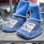 A pair of blue socket-shoes with childish design from the local shop, Kråkeslottet.