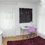 One of the colorful and artistic bedrooms at Mileperlen Gallerihotell with the artist and owner’s own paintings.