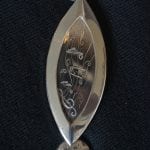 One part of the silver ceremonial chain of office for the Mayor. This one has music notes on it.