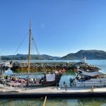 The marina at Hemnesberget with boats and people enjoying the sunny day from the boat with a great view of Sundholmen.