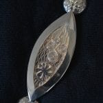 One part of the silver ceremonial chain of office for the Mayor. This one representing waterpower.