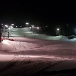 Down hill slopes in Bleikvasslia at night with only the slopes lit up in white and pink lighting.