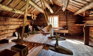Building of boats made of wood inside an old wooden building.