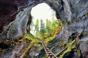 The big and fascinating hole in the ground, Jettegryter, seen from below and up to the opening with the ladder to climb up