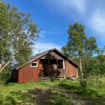 A small brown wooden annex house.