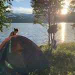 A tent by the lake Kjensvatnet in the sunset.