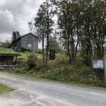 Entrance to Inderdalen Farm with signs and information about the Okstindan mountains.