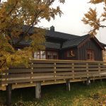 Brown house with a big veranda.