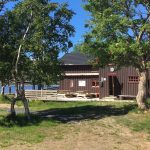 Nice brown cabin with veranda by the lake