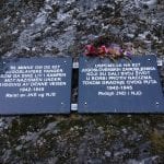 Signs in Norwegian and Serbian, honouring 627 prisoners who died during world war 2 building the blood road over Korgfjellet.
