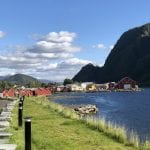 Colorful houses next to the fjord in Mosjøen with the tall mountain, Øyfjellet in the background on a sunny summer day.