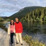 A couple standing on the nice walking path alongside the river, Røssåga in Korgen on a sunny summer day.