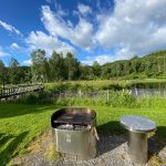 Grill next to a lake and a path