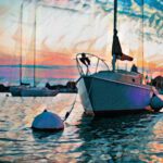 Several sailboats in the sunset